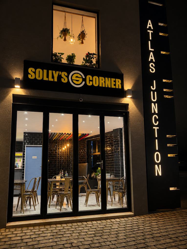 Solly's Corner Atlas Junction storefront lit at night in Beyers Park, Boksburg
